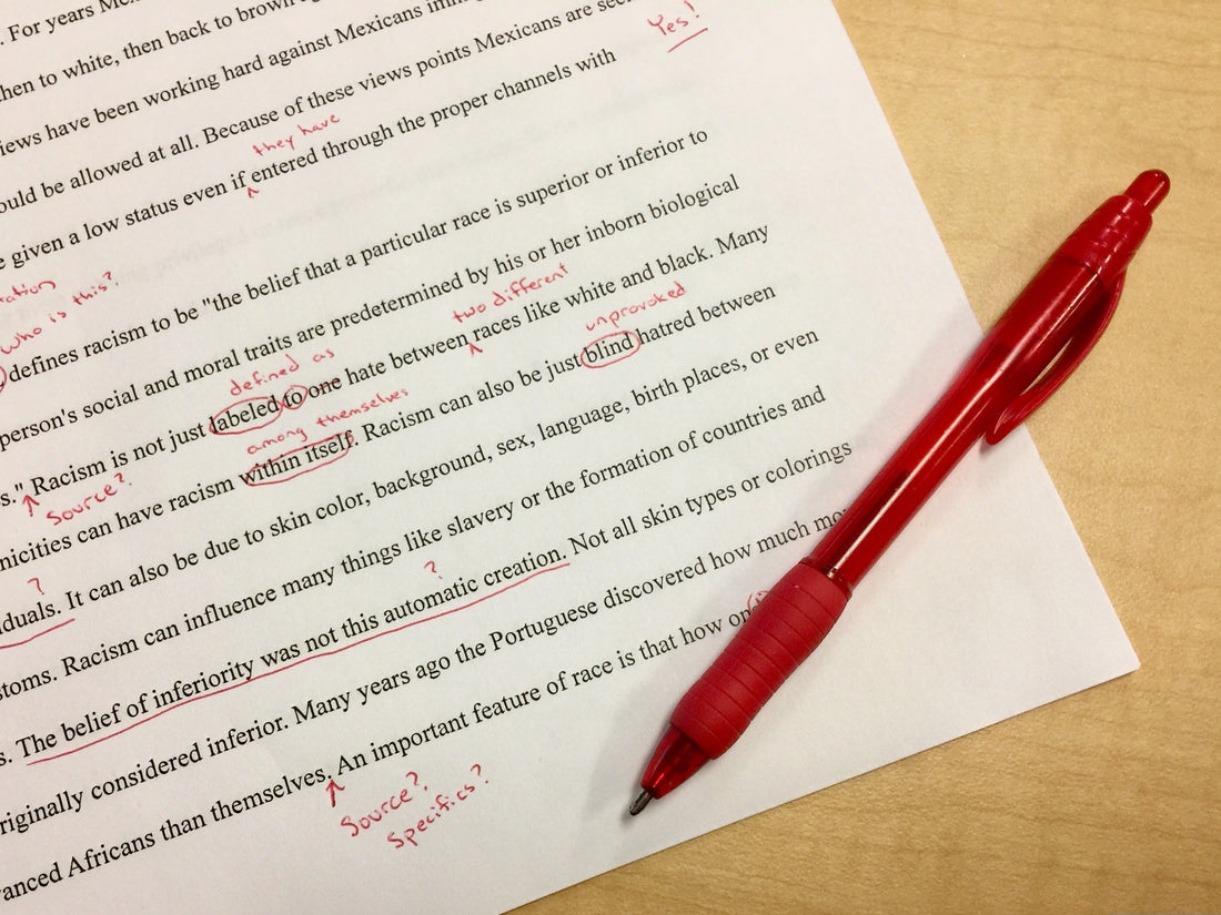 Red pen editing a page of text for book lovers