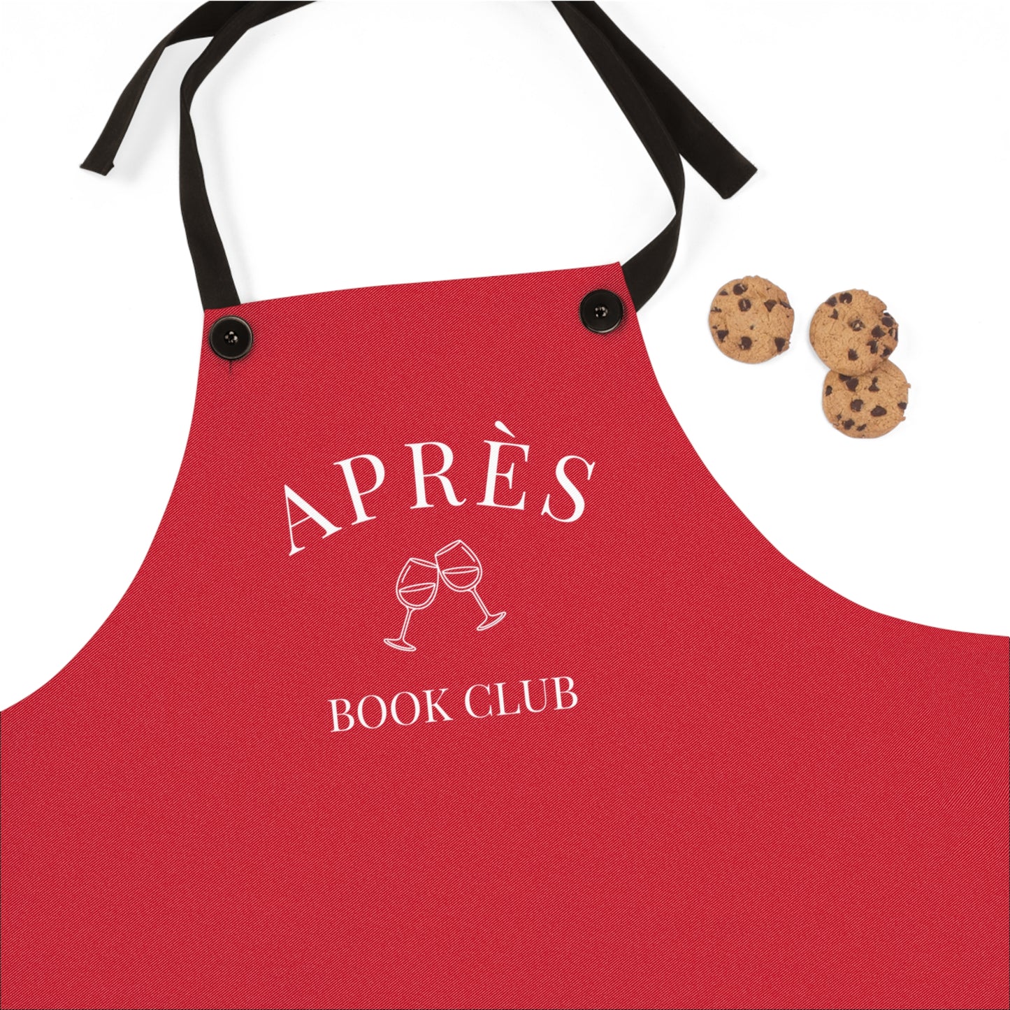 Red apron with 'APRÈS BOOK CLUB' text and wine glass graphics on a white background.