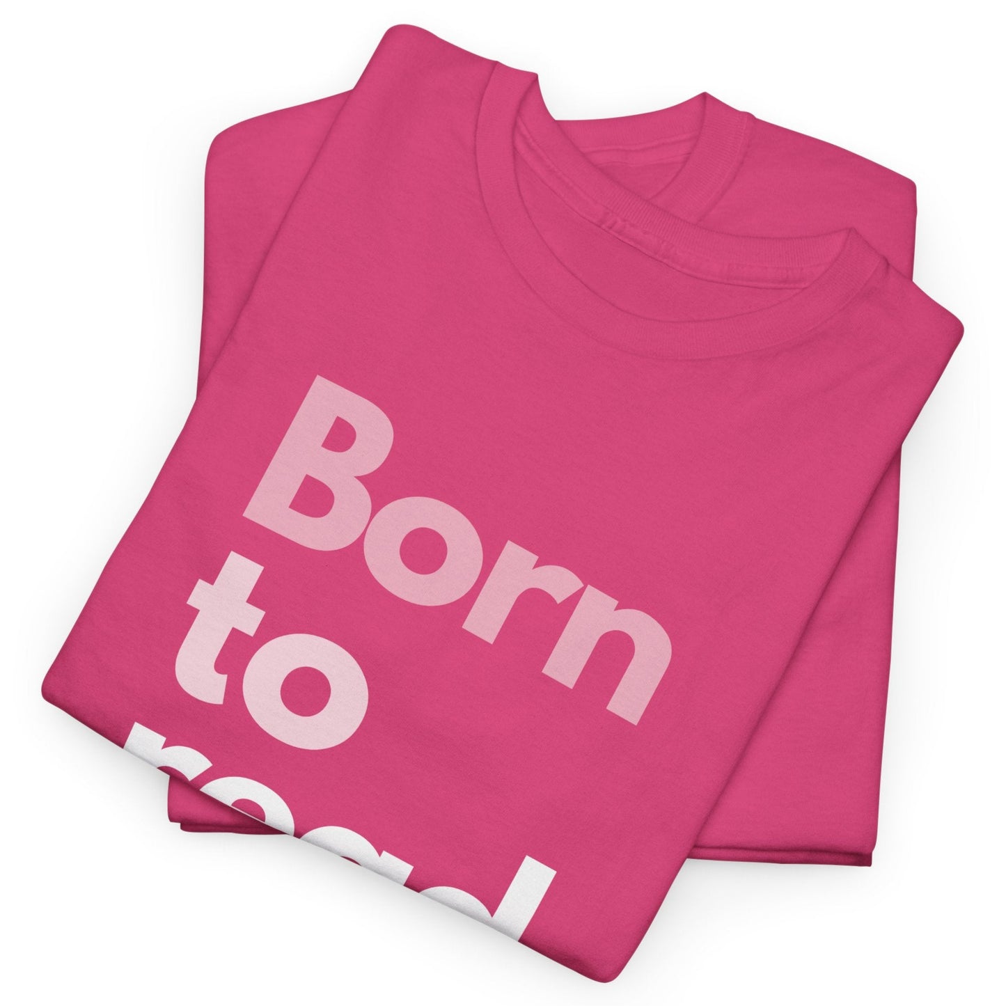 Folded pink t-shirt with 'Born to' text on a white background