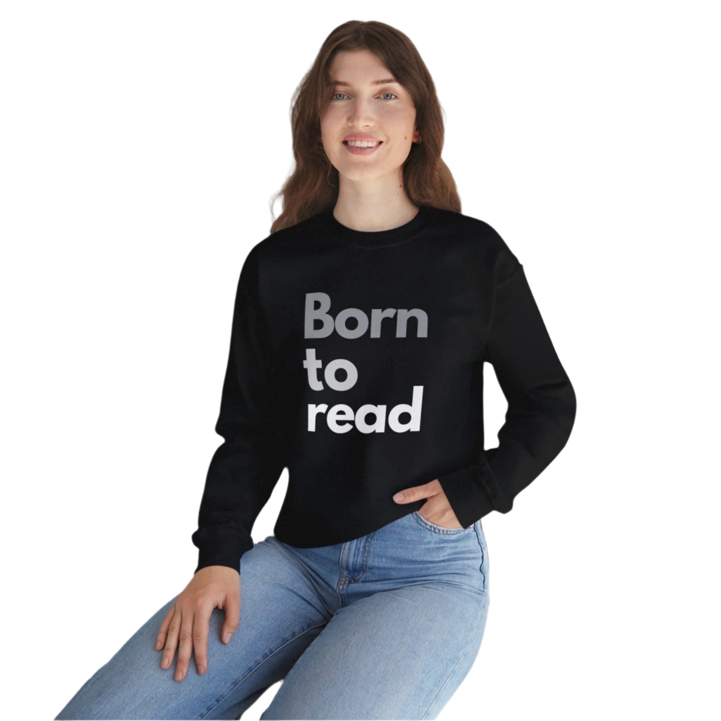 Person wearing a black sweatshirt with 'Born to read' text, sitting on a white surface with a plant in the background.