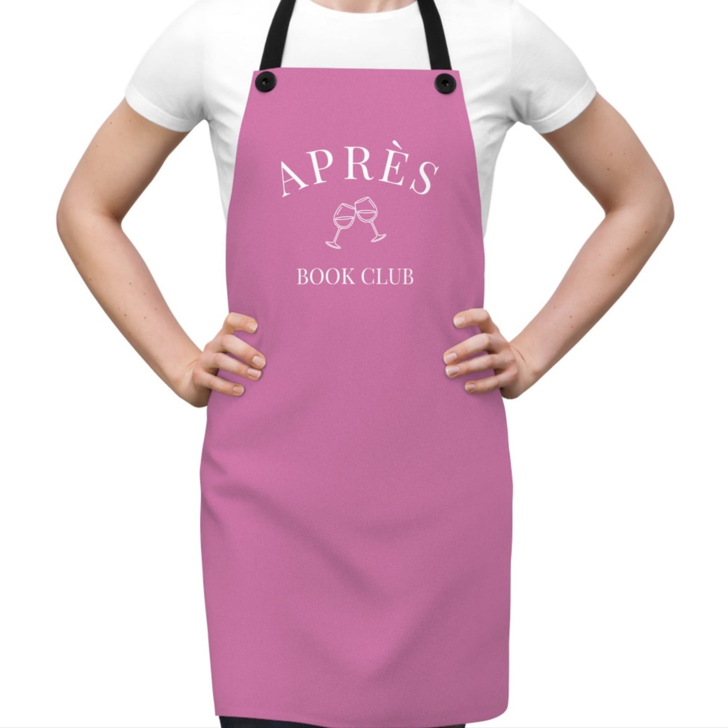 Person wearing a pink apron with 'APRèS BOOK CLUB' text on a white background