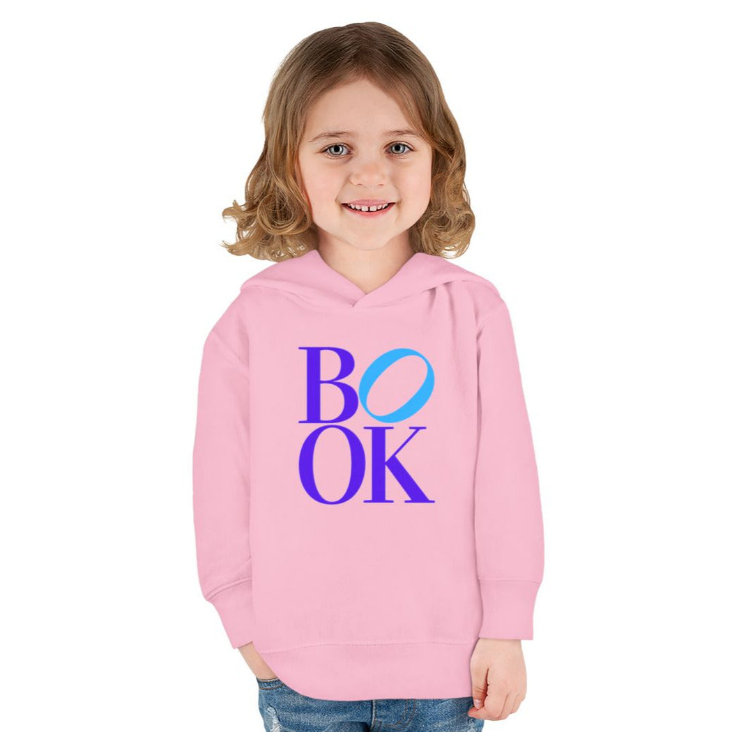 Child wearing a pink hoodie with 'BOOK' printed on it against a white background