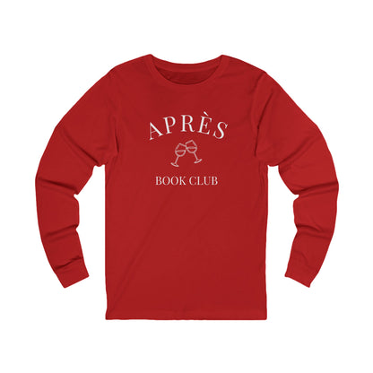 Red long-sleeve shirt with 'Apres Book Club' text and wine glass graphics on a white background