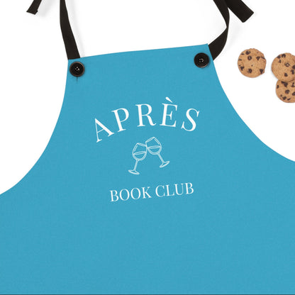 Blue apron with 'APRÈS BOOK CLUB' text and wine glass design, accompanied by cookies on a white background.