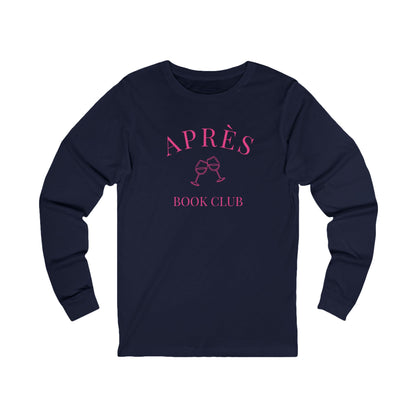 Navy blue long-sleeve shirt with pink 'APRèS BOOK CLUB' text and wine glass graphic on a white background