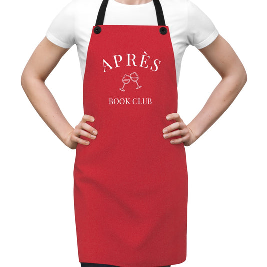 Red apron with 'APRèS BOOK CLUB' text worn by a person on a white background
