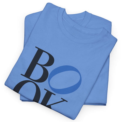 Folded blue t-shirt with 'BOY' printed on it against a white background
