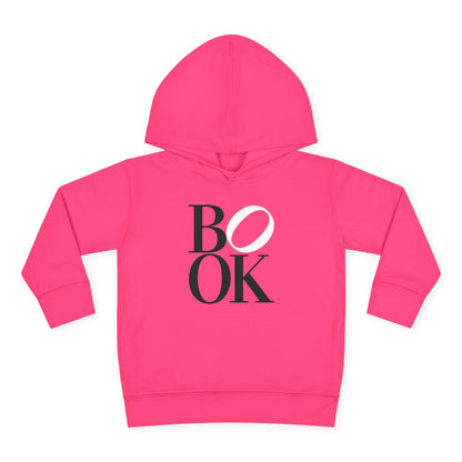 Pink hoodie with 'BOOK' printed on it against a white background