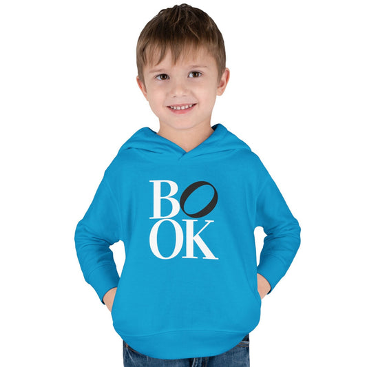 Child wearing a blue hoodie with 'BOOK' text on a white background