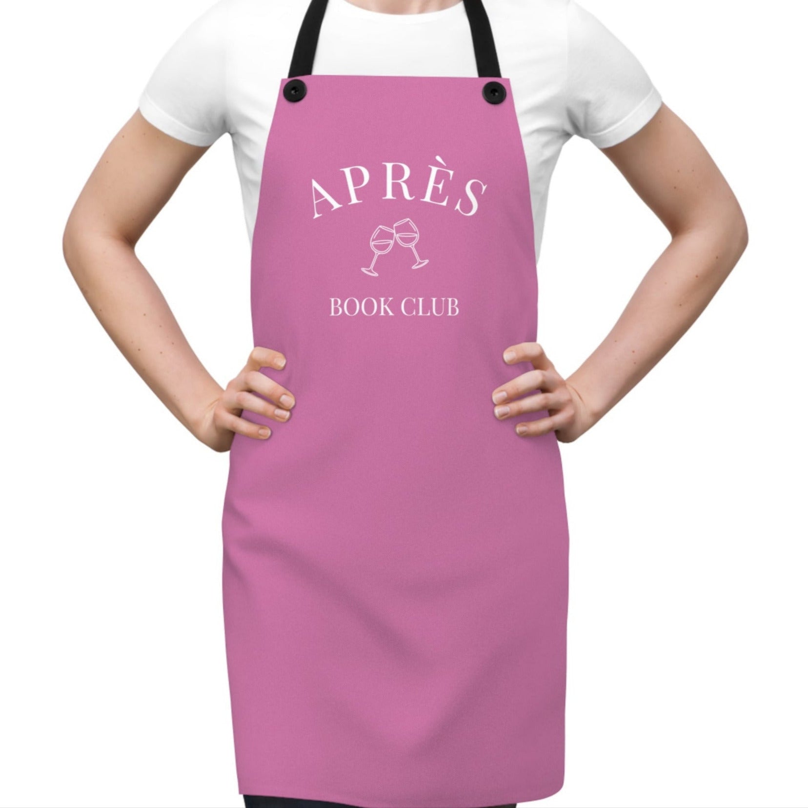 Person wearing a pink apron with 'APRèS BOOK CLUB' text on a white background