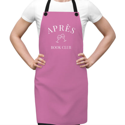 Person wearing a pink apron with 'APRèS BOOK CLUB' text on a white background