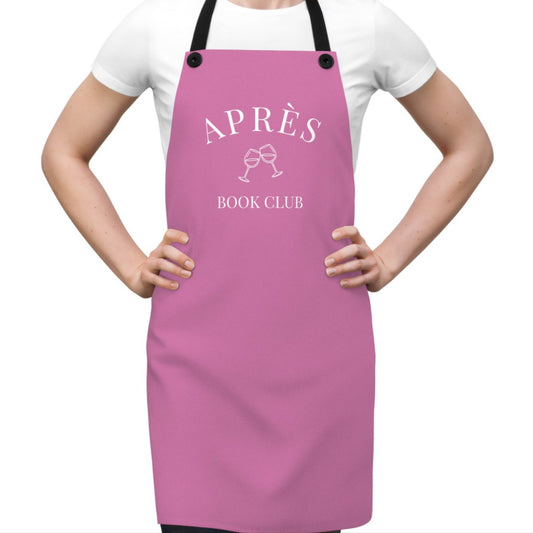 Person wearing a pink apron with 'APRèS BOOK CLUB' text on a white background