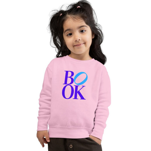 Child wearing a pink sweatshirt with 'BOOK' printed on it against a white background